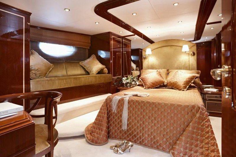 a bedroom with a bed and a couch aboard IRAKLIS L Yacht for Charter