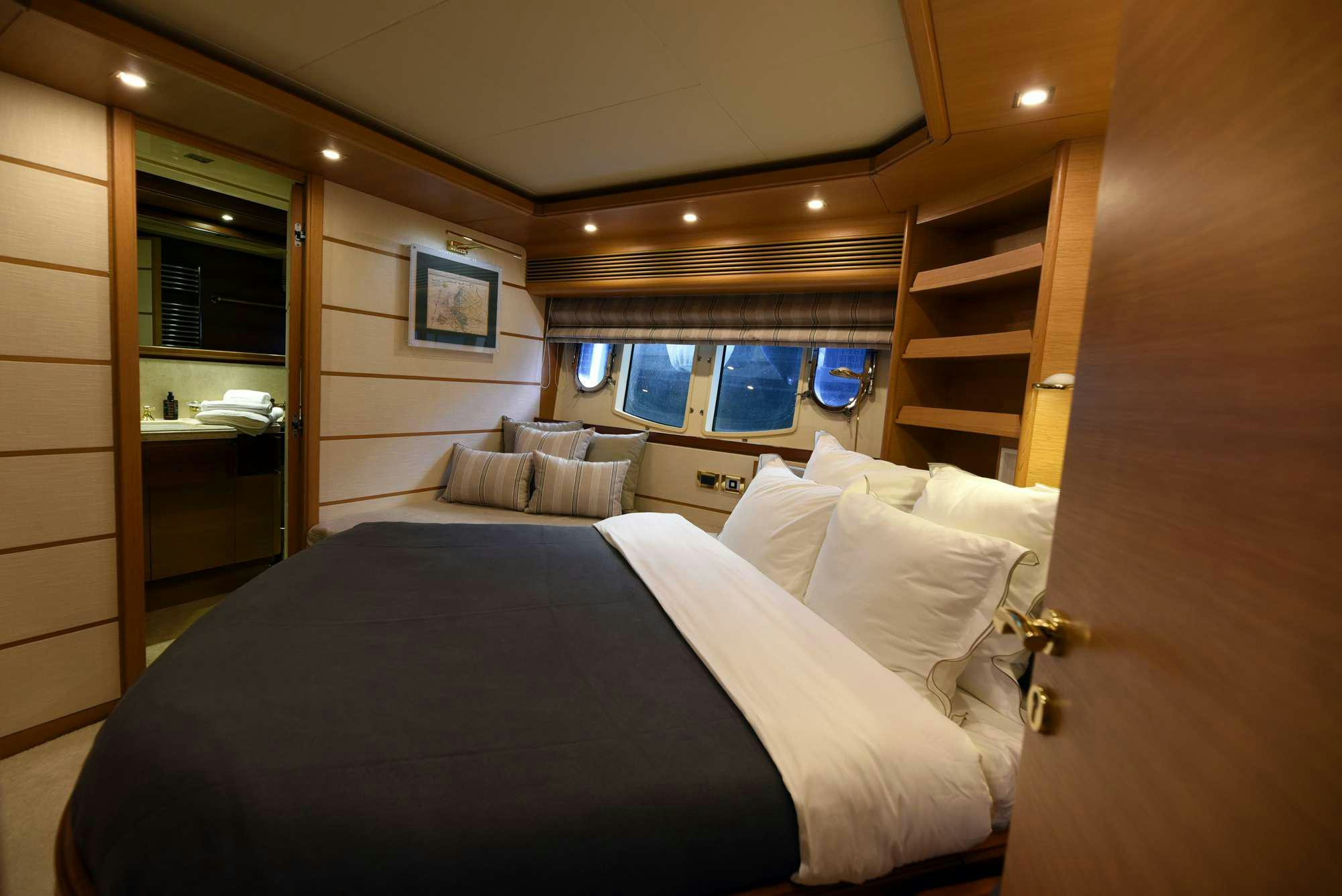 a room with a bed and a window aboard PAREAKKI Yacht for Charter