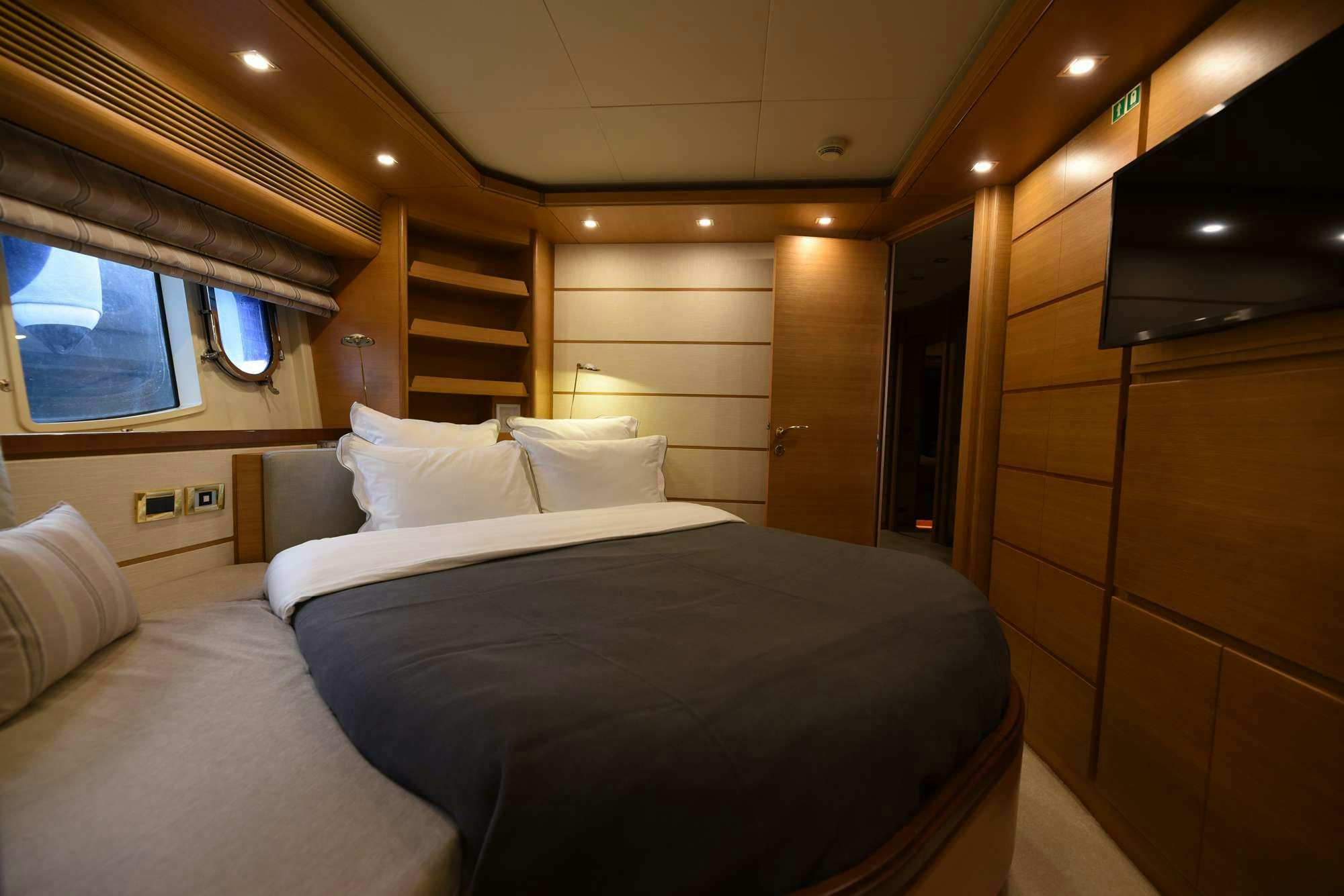 a room with a bed and a window aboard PAREAKKI Yacht for Charter