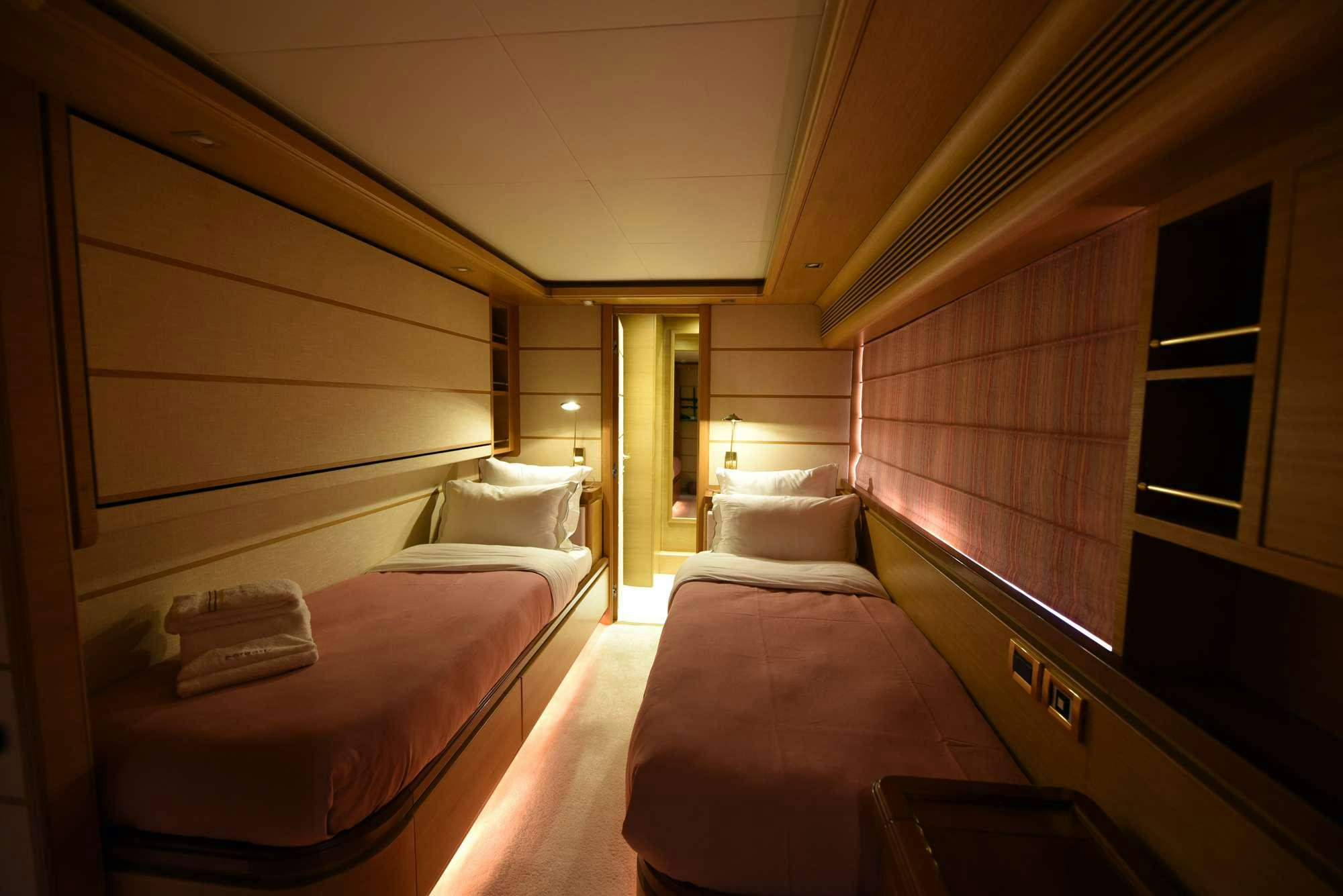 a room with beds and a window aboard PAREAKKI Yacht for Charter