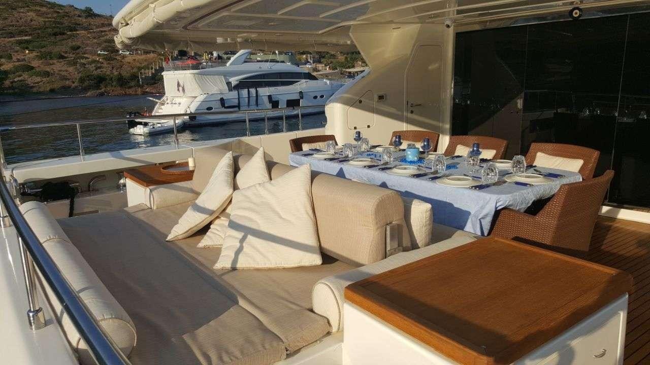 a room with a table and chairs aboard PAREAKKI Yacht for Charter