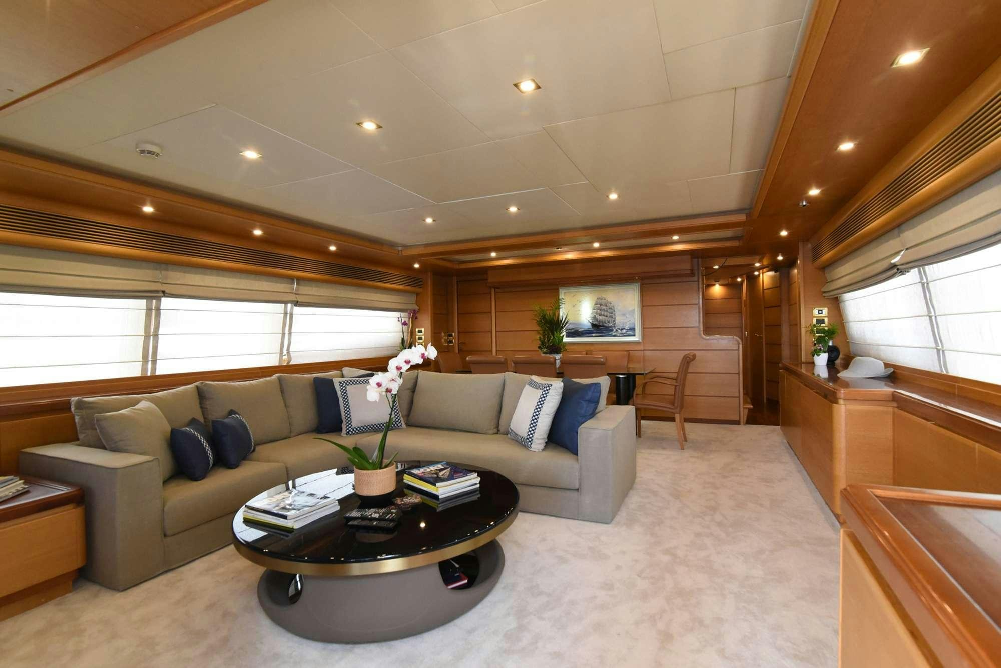 a living room with a couch and a coffee table aboard PAREAKKI Yacht for Charter