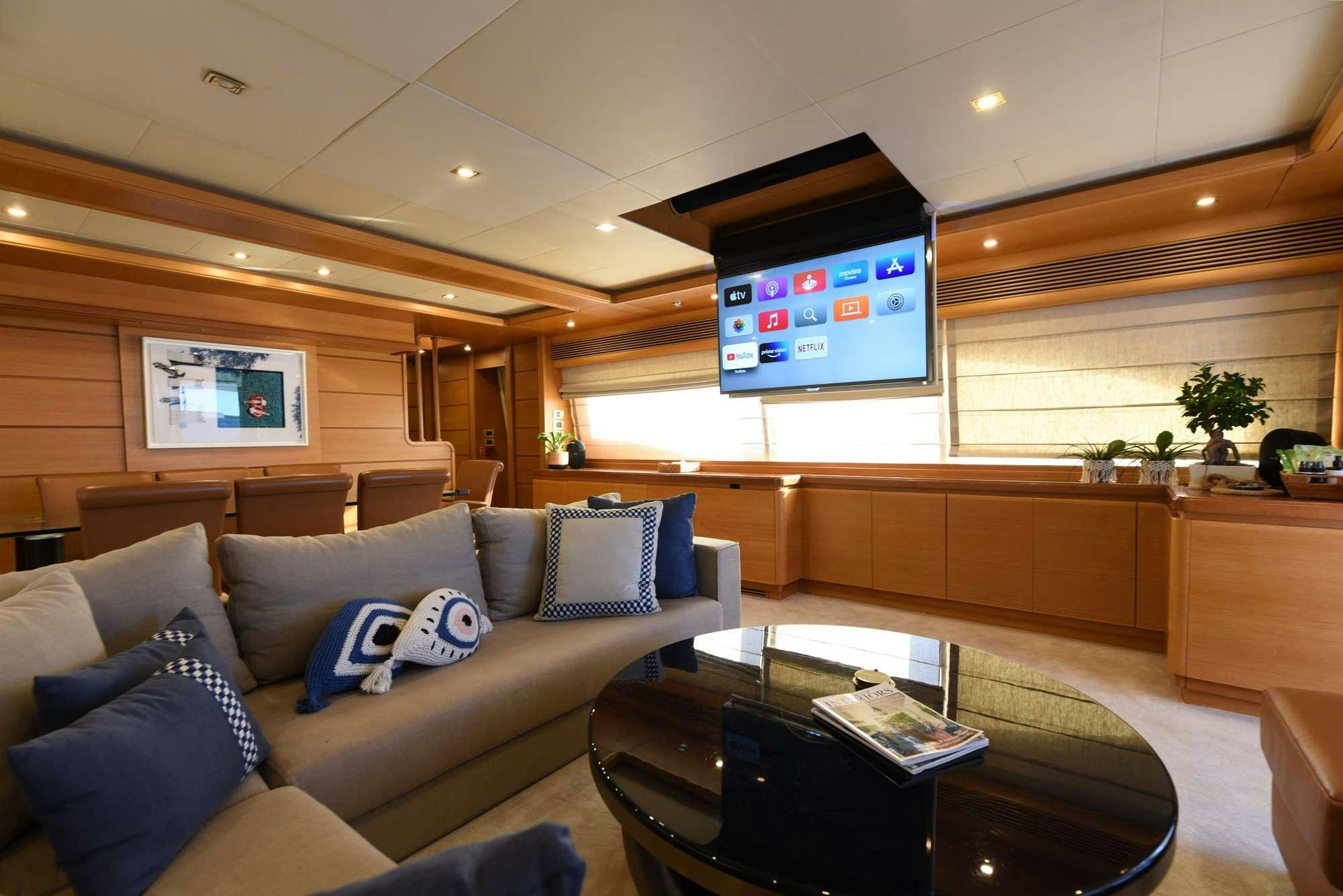 a living room with a couch and tv aboard PAREAKKI Yacht for Charter