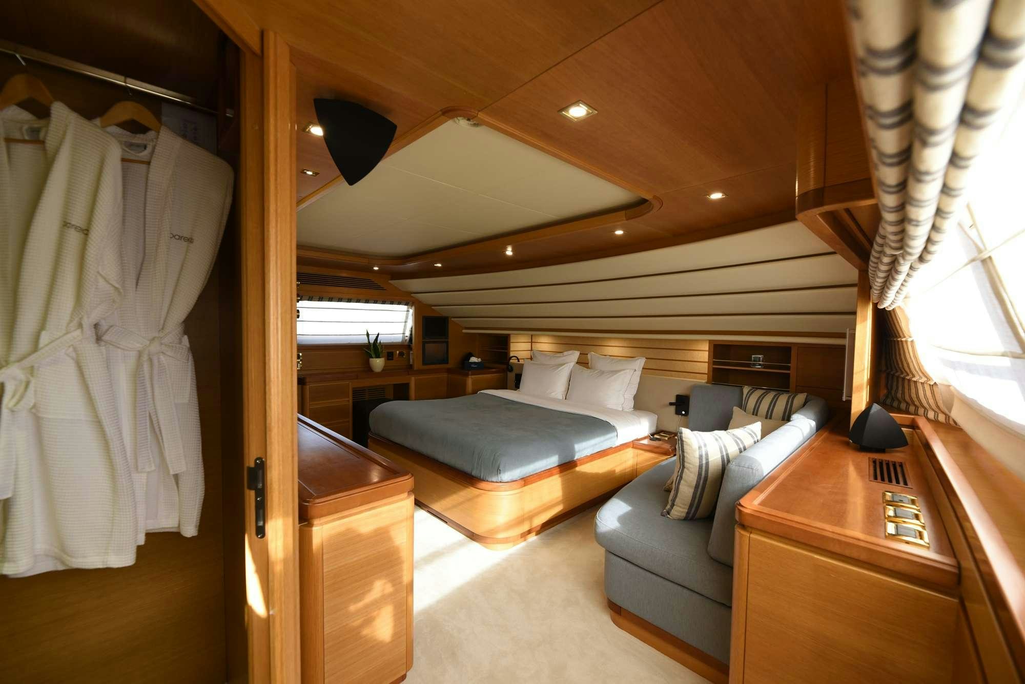 a room with a bed and a desk aboard PAREAKKI Yacht for Charter