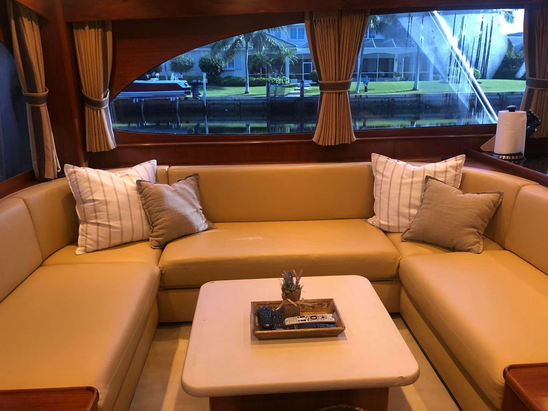 a couch with pillows and a table aboard BONNIE T Yacht for Charter