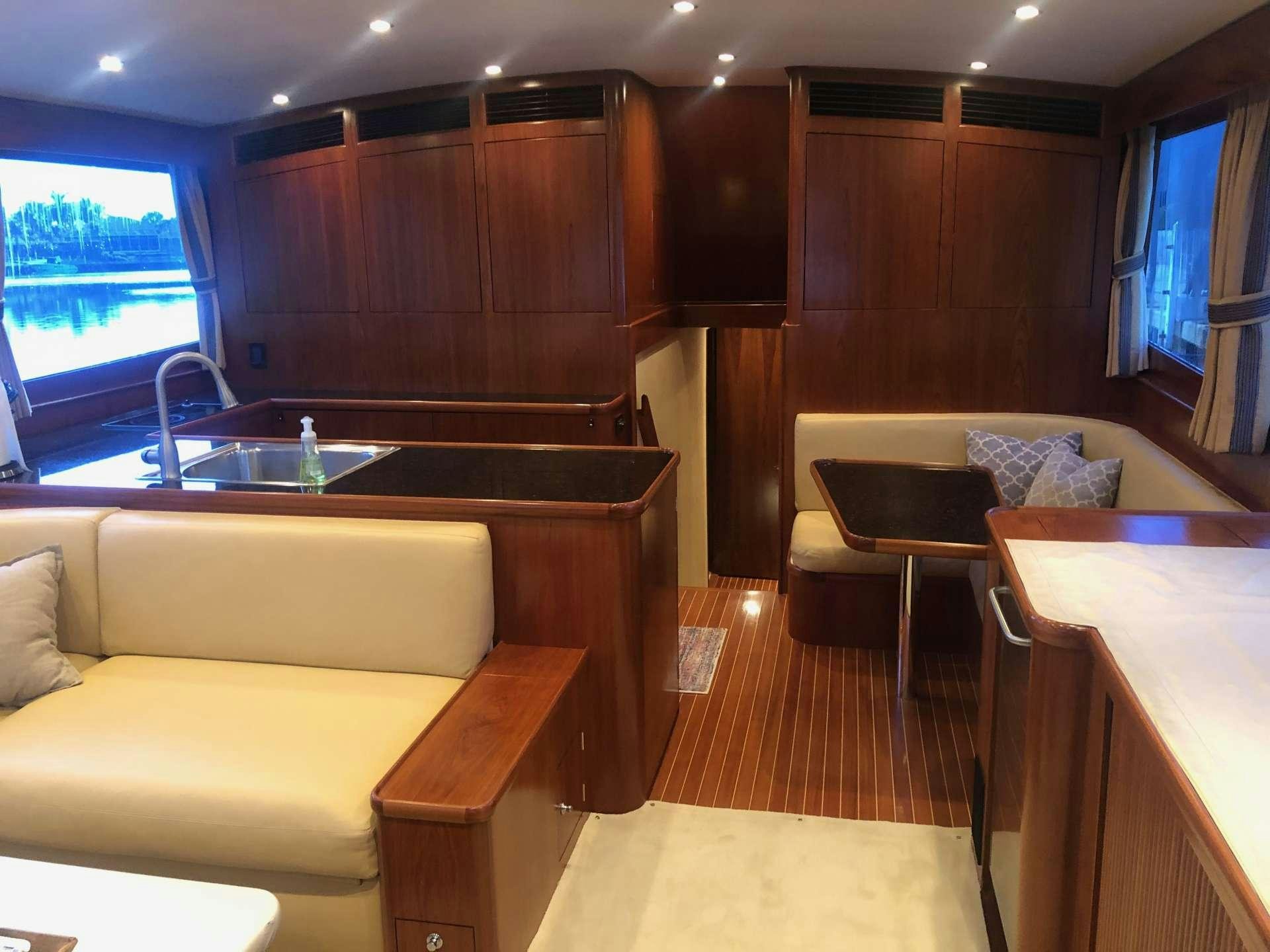 a living room with a kitchen and a dining table aboard BONNIE T Yacht for Charter