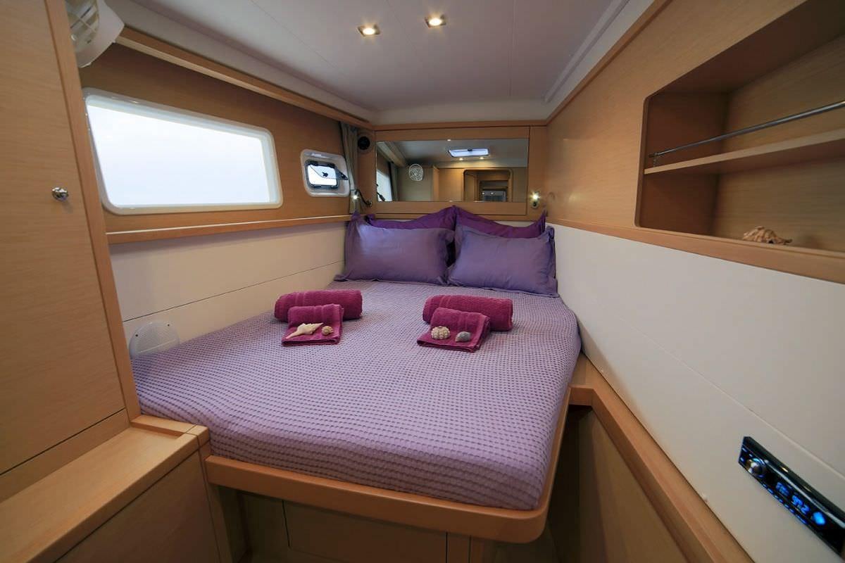 a bedroom with a bed and a desk aboard DANIELA II Yacht for Charter