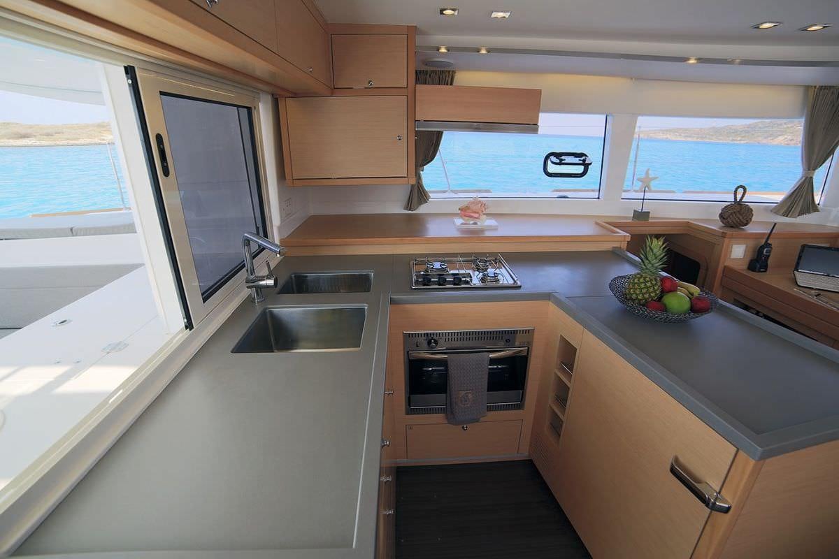 a kitchen with a sink and cabinets aboard DANIELA II Yacht for Charter