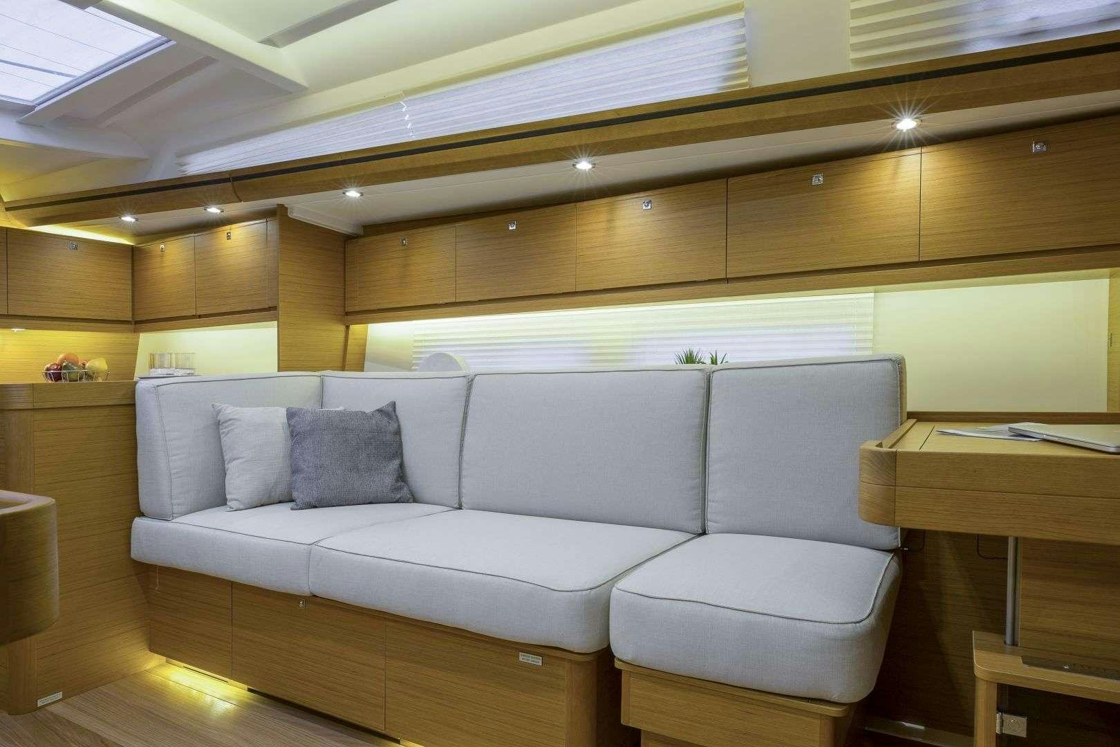 a white couch in a room aboard Euribia Yacht for Charter