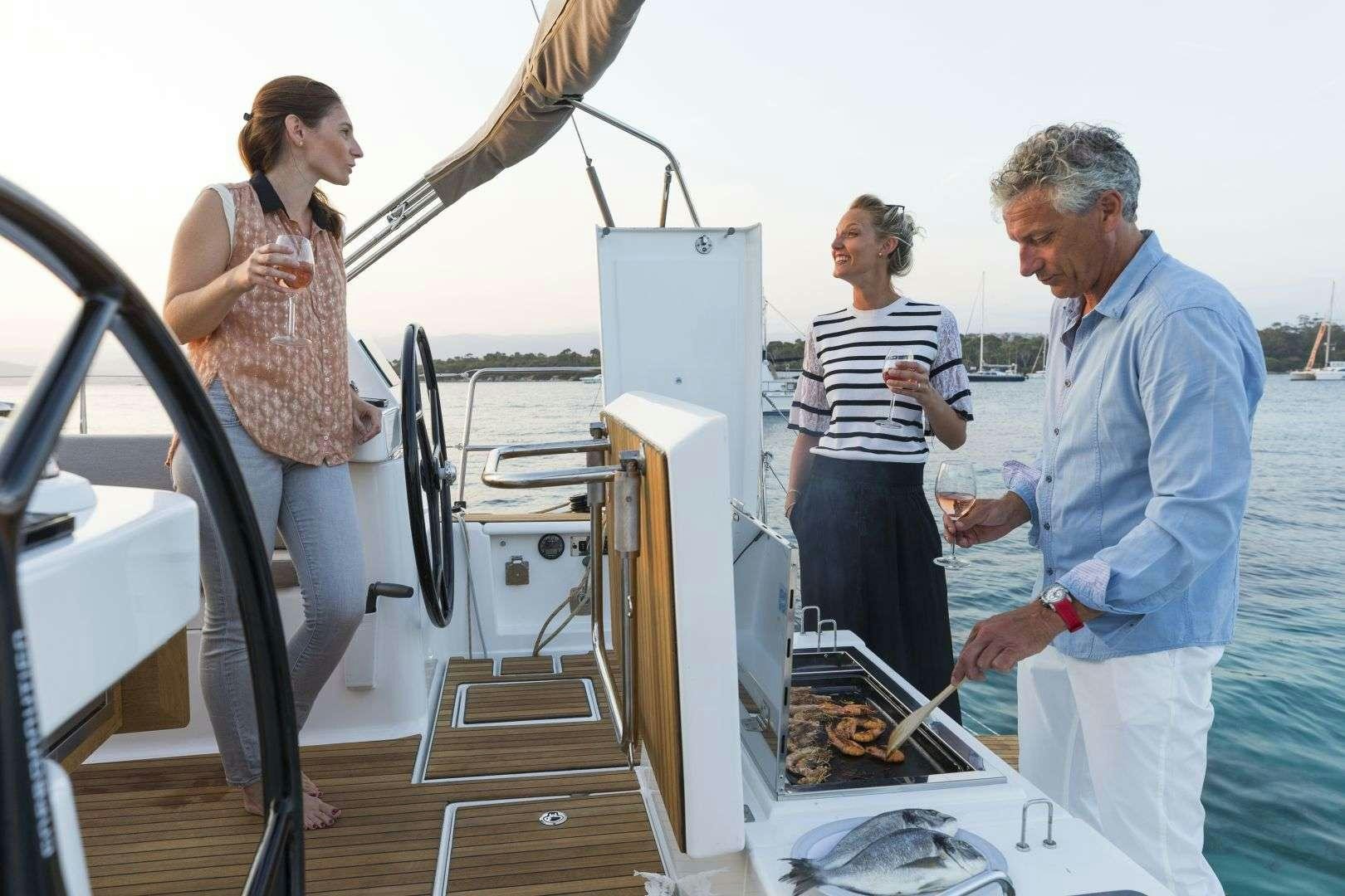 a few people standing around a table aboard Euribia Yacht for Charter