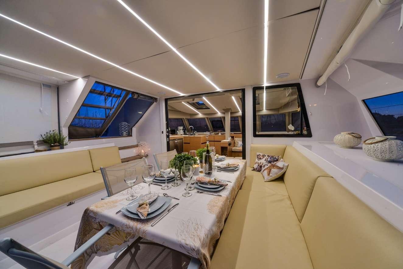 a dining room with a table aboard ODYSSEY Yacht for Charter