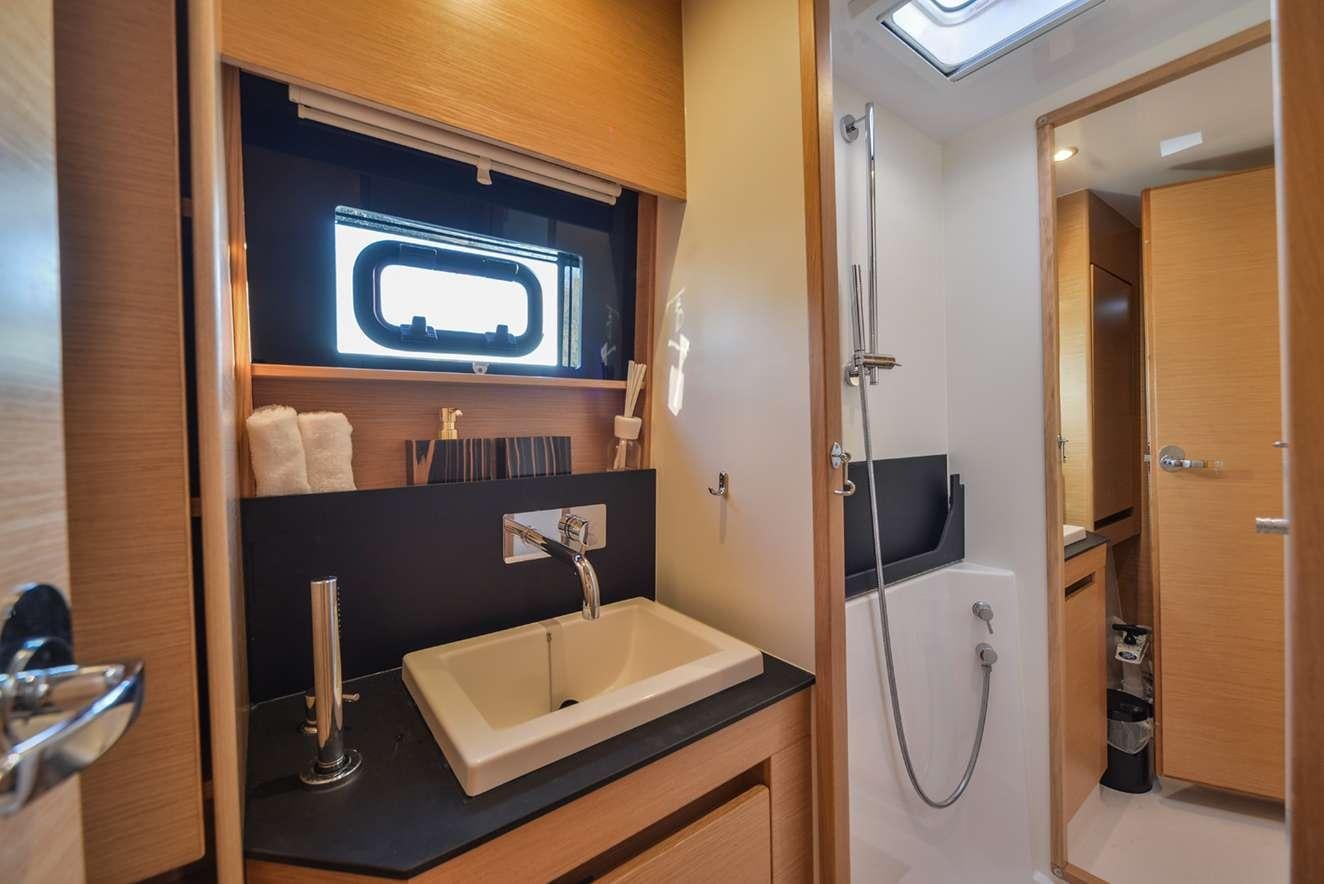 a bathroom with a sink and a mirror aboard ODYSSEY Yacht for Charter