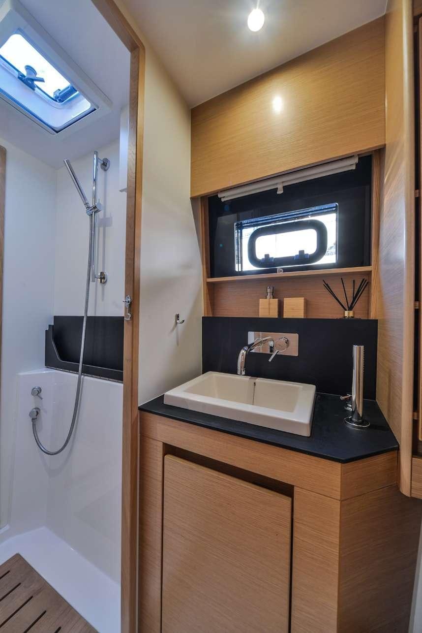 a bathroom with a sink and a tv on the wall aboard ODYSSEY Yacht for Charter