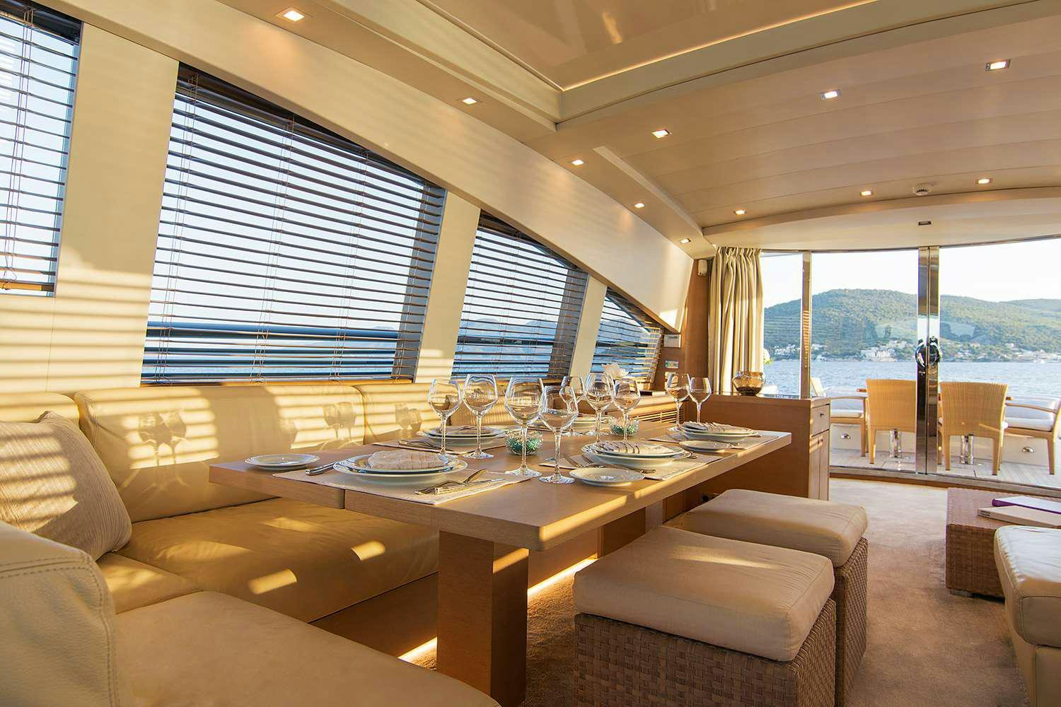 a room with a table chairs and a window aboard SUN ANEMOS Yacht for Charter