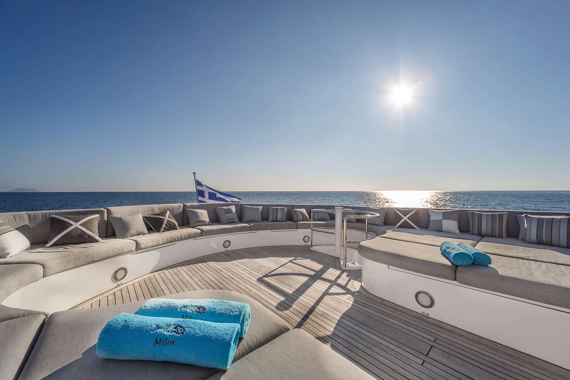 a couple of beds on a beach aboard MILOS AT SEA Yacht for Charter