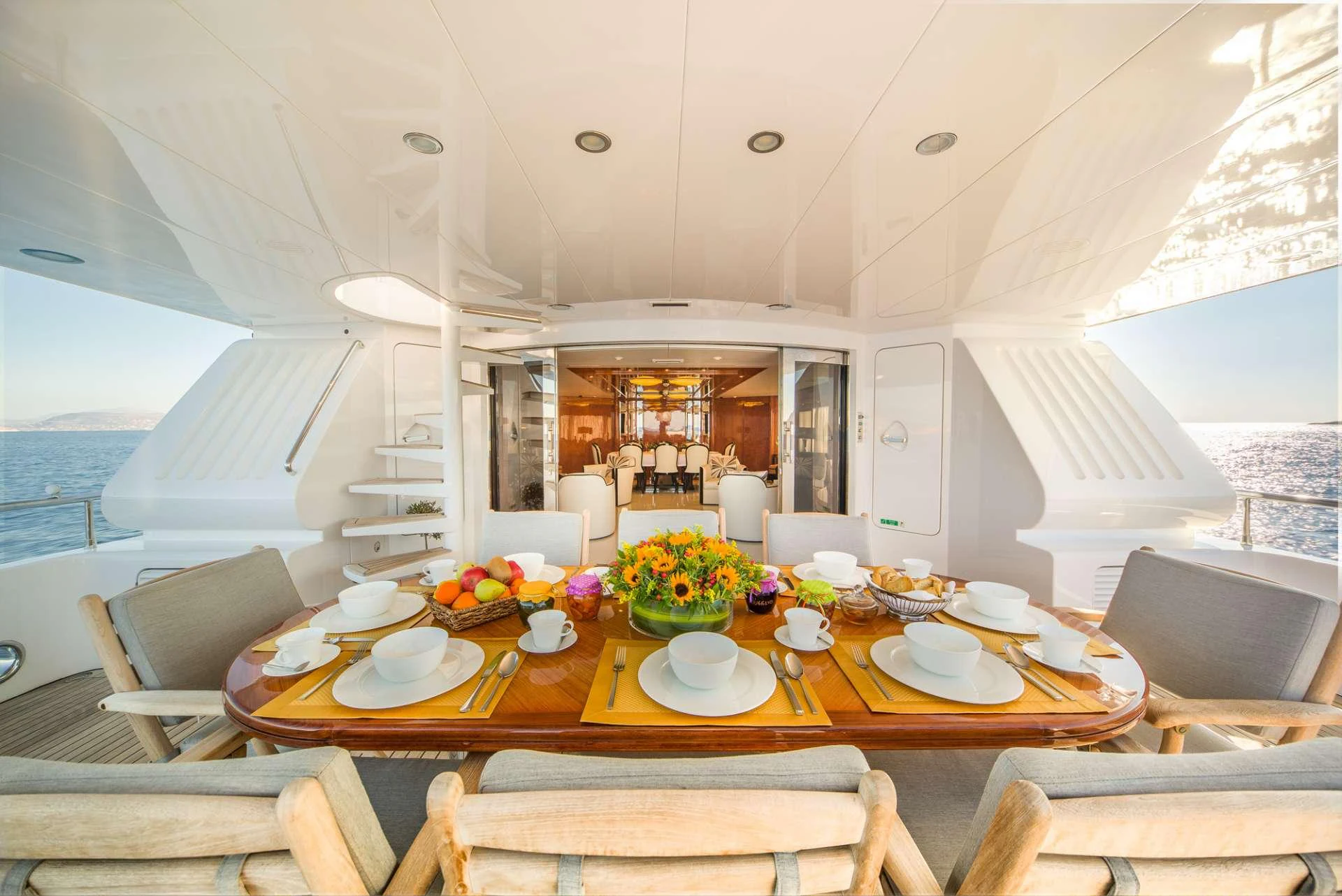 a dining room with a table set aboard MILOS AT SEA Yacht for Charter