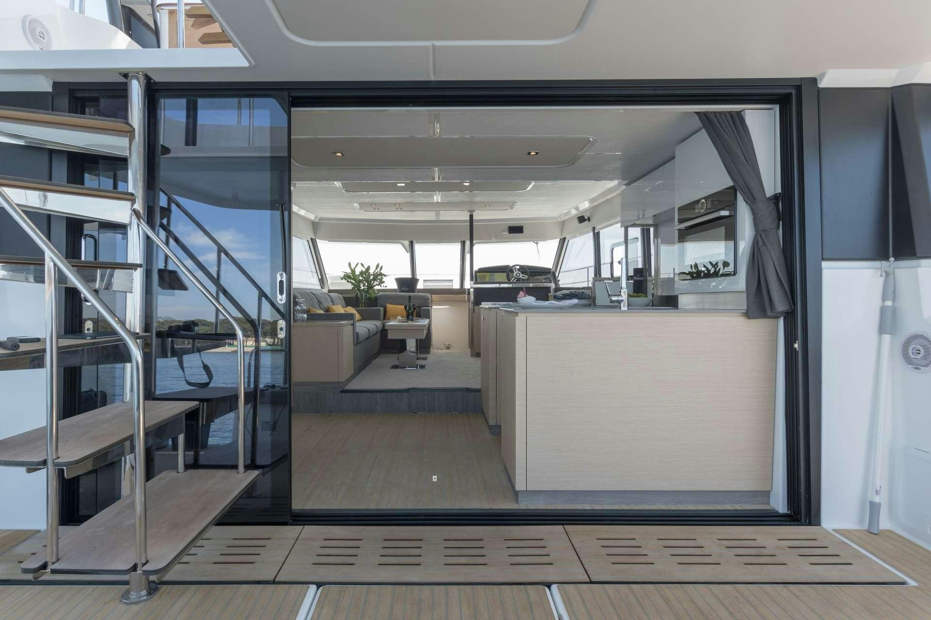 a large room with a large glass door and a staircase aboard ENDLESS BEAUTY Yacht for Charter