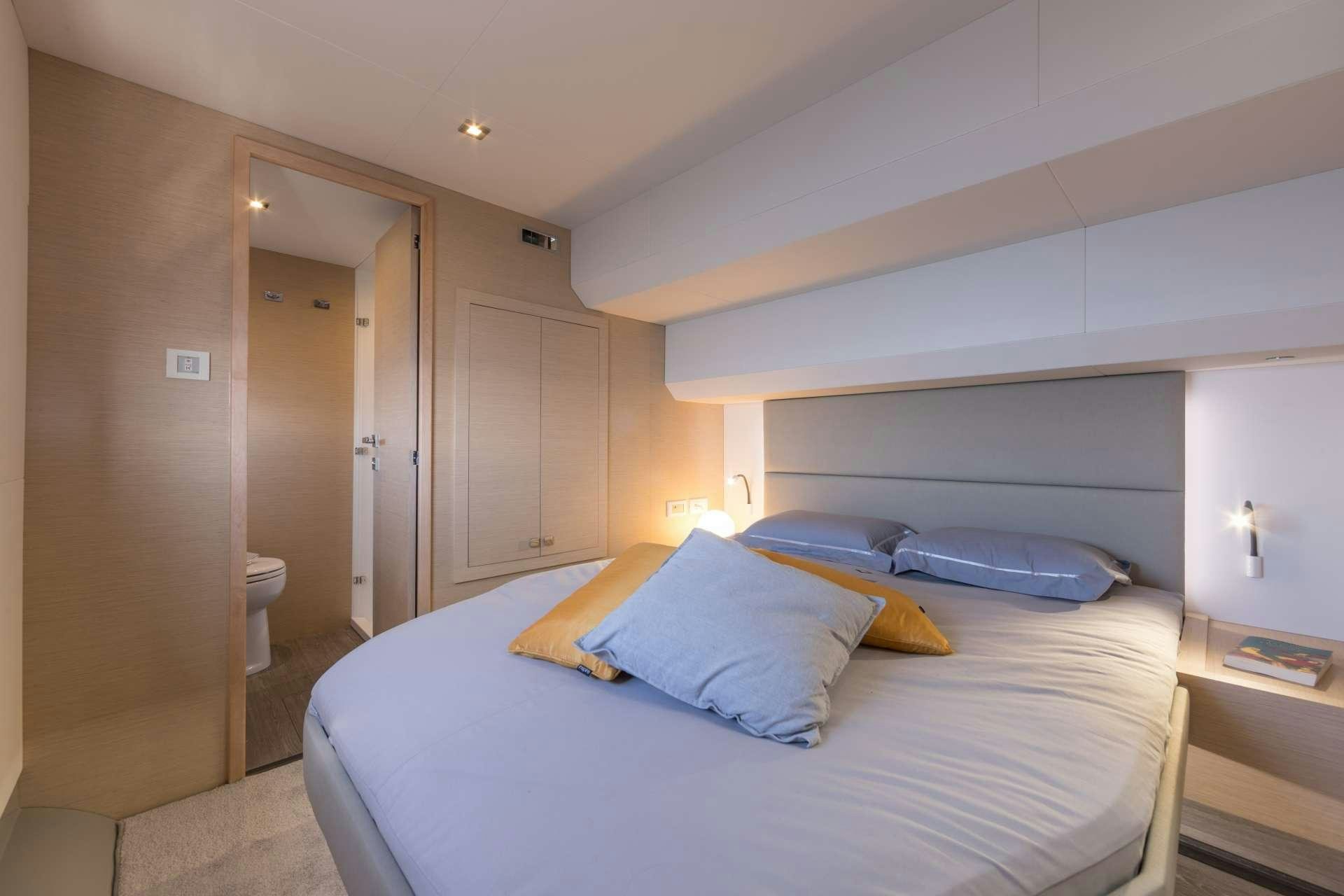 a bedroom with a bed and a closet aboard ENDLESS BEAUTY Yacht for Charter