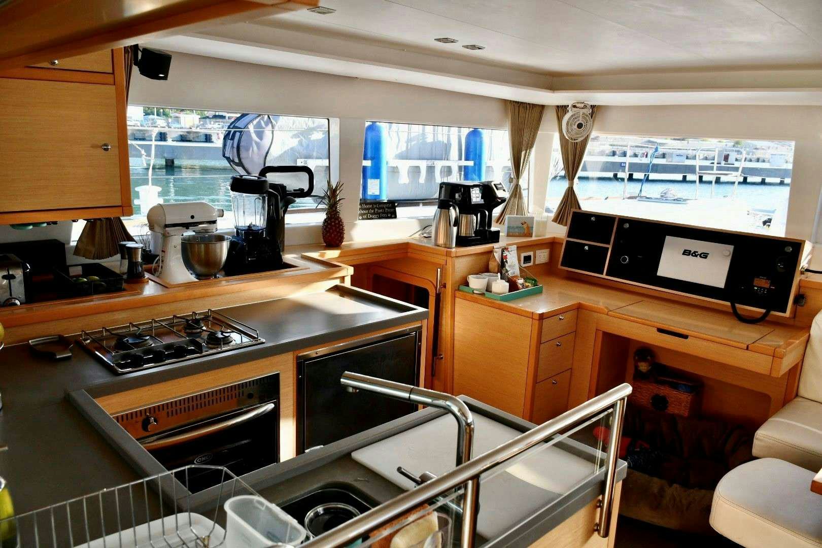 a kitchen with a large window aboard CHAOS INTERRUPTED Yacht for Charter