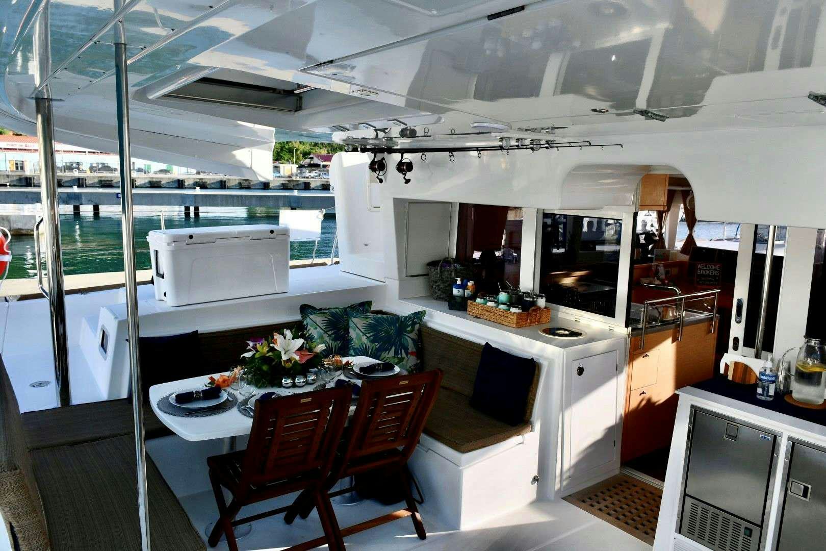 a kitchen with a table and chairs aboard CHAOS INTERRUPTED Yacht for Charter
