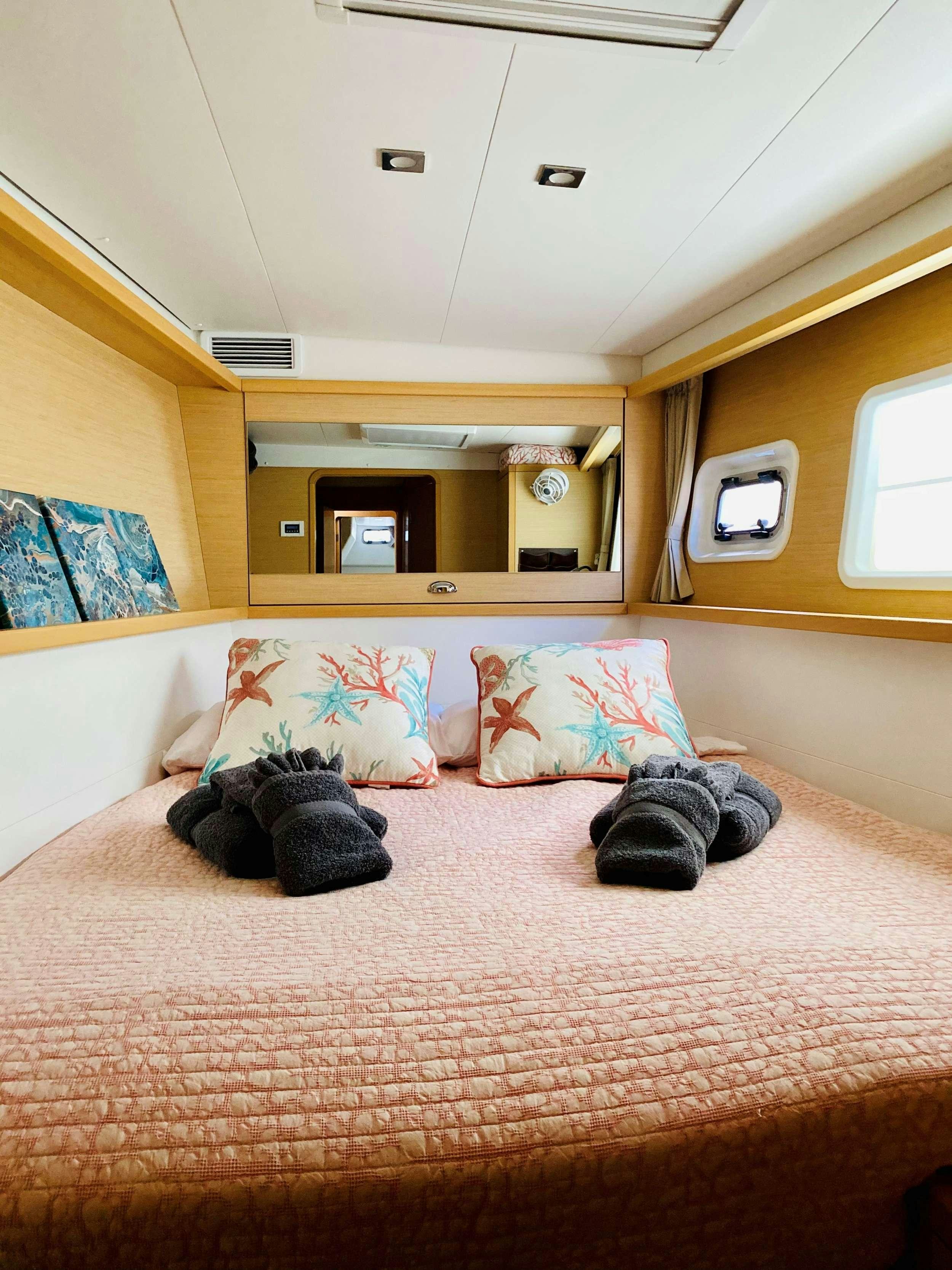 a bed with pillows on it aboard CHAOS INTERRUPTED Yacht for Charter
