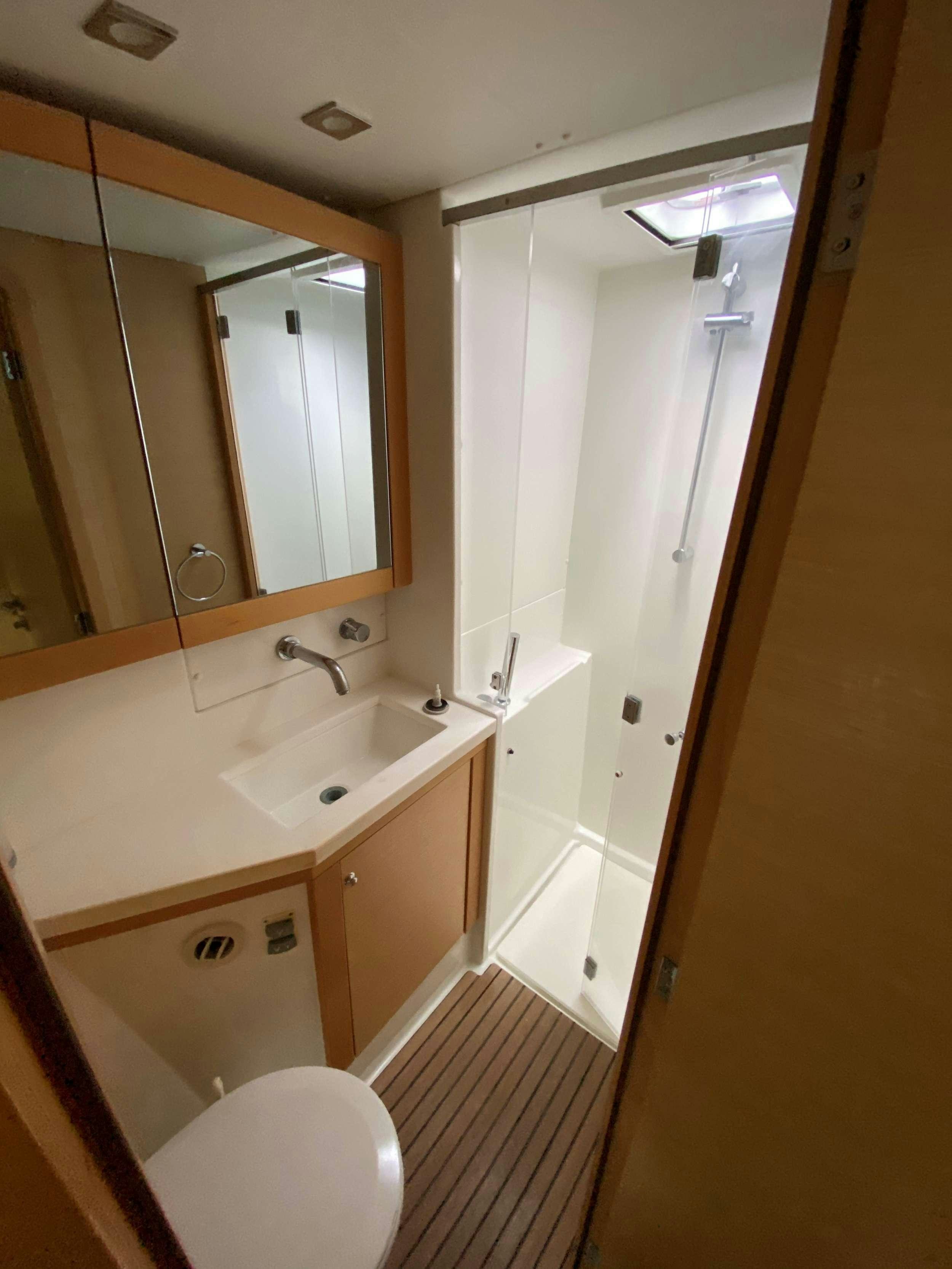 a bathroom with a large mirror aboard CHAOS INTERRUPTED Yacht for Charter