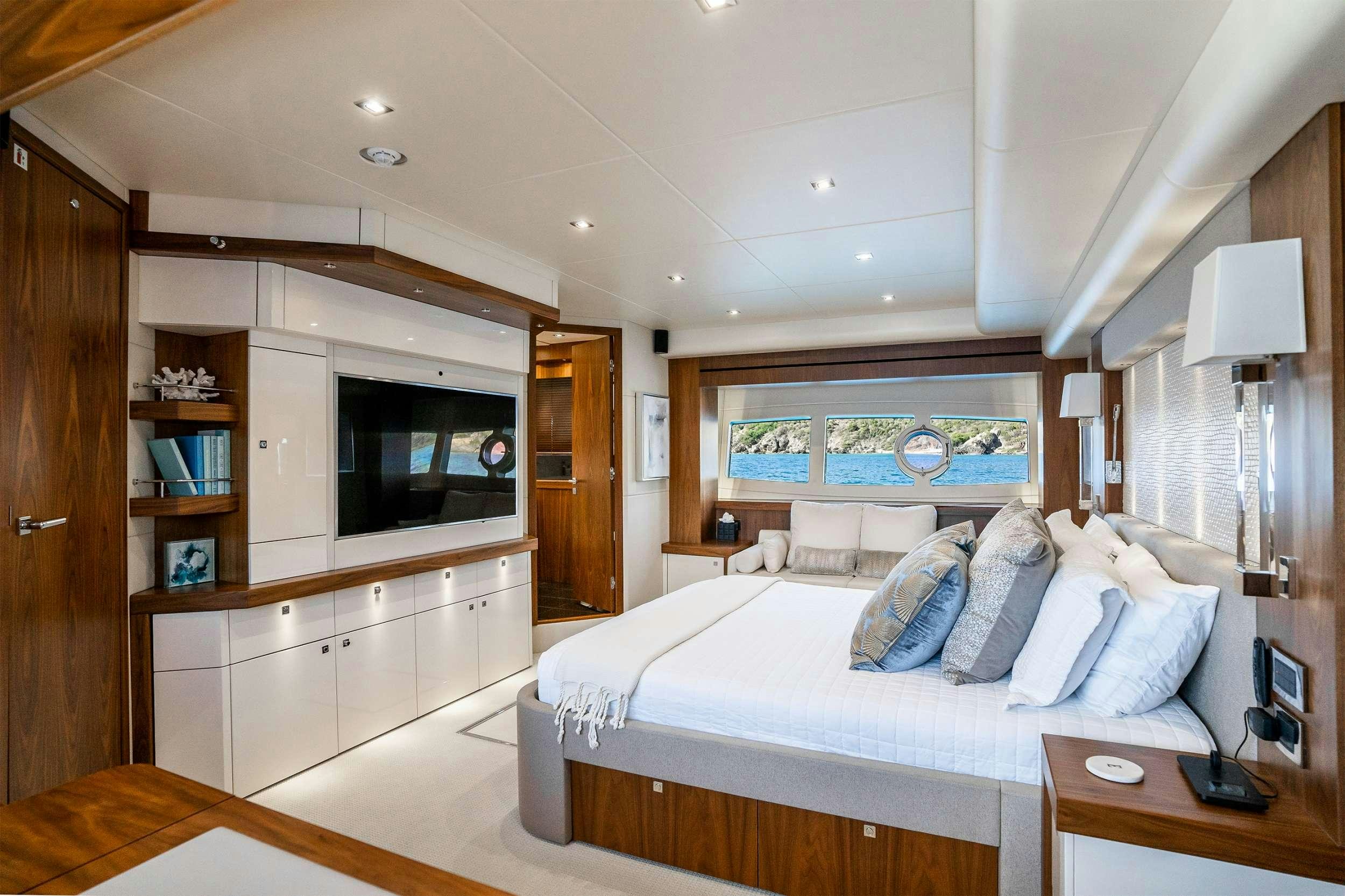 a bedroom with a bed and a desk aboard ELITE Yacht for Charter