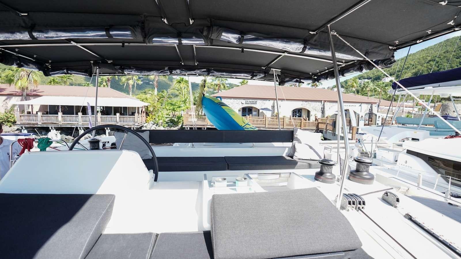 a deck with a pool and a building in the background aboard FLOATATION THERAPY Yacht for Charter