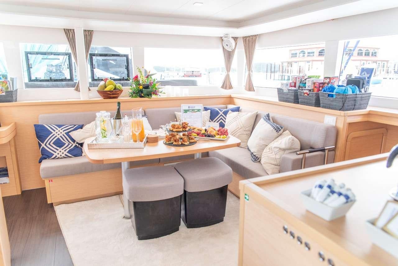 a living room with a couch and a table aboard FLOATATION THERAPY Yacht for Charter