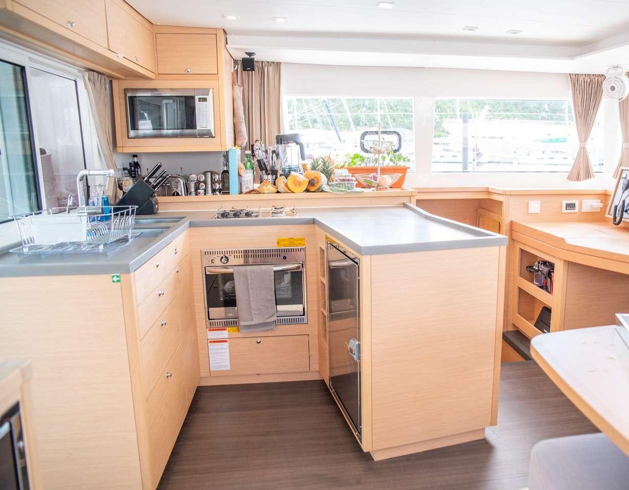 a kitchen with a microwave oven and cabinets aboard FLOATATION THERAPY Yacht for Charter