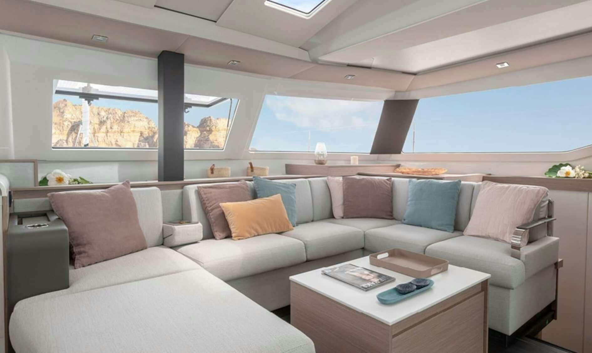 a white couch with pillows aboard Ruckus Yacht for Charter