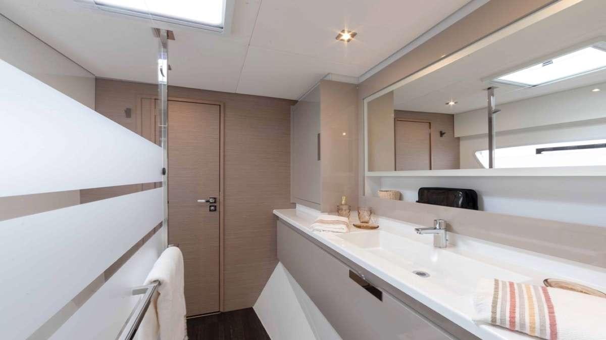 a bathroom with a sink and a bathtub aboard Ruckus Yacht for Charter
