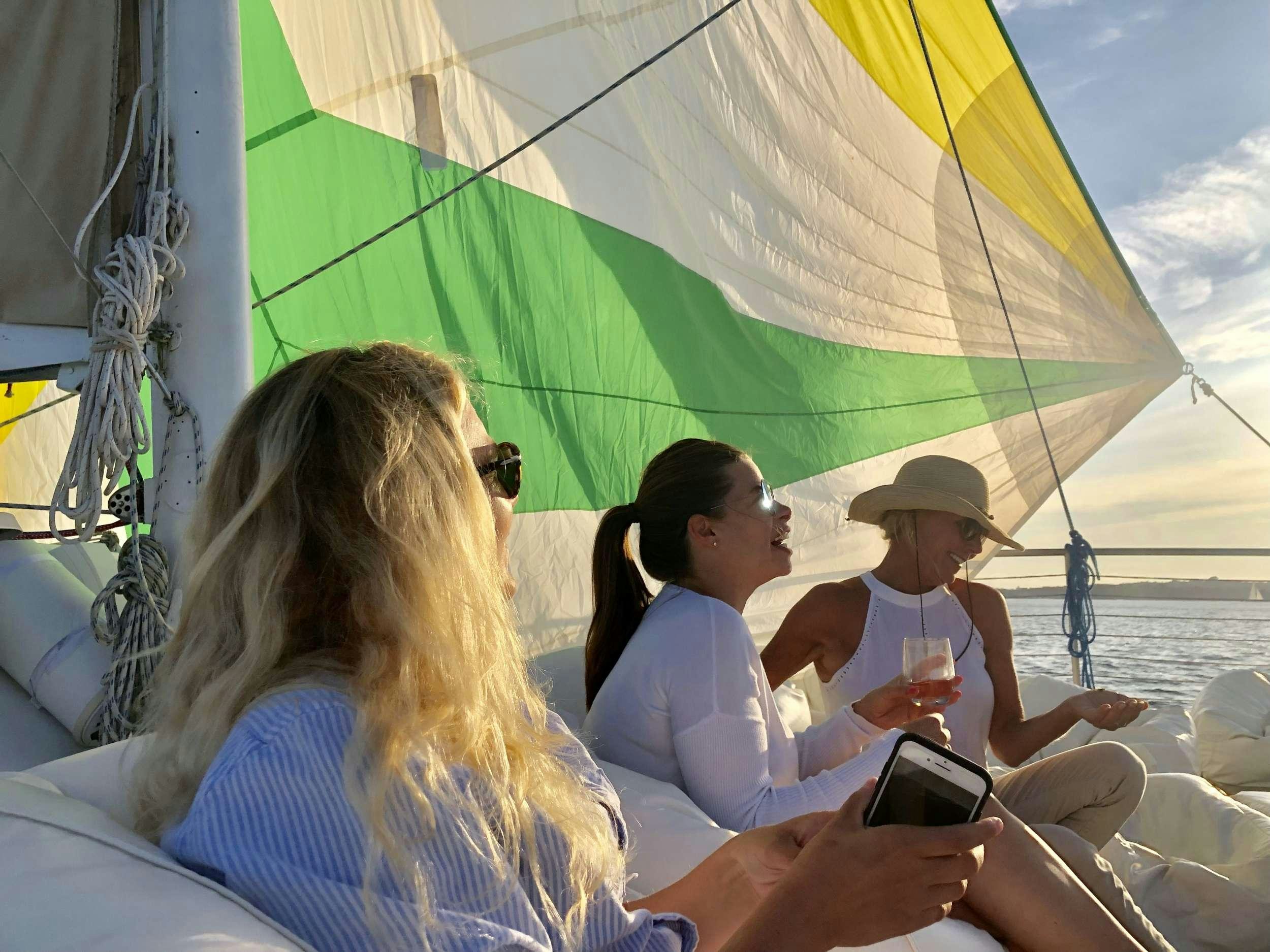 a group of people sitting on a boat aboard HERON Yacht for Charter