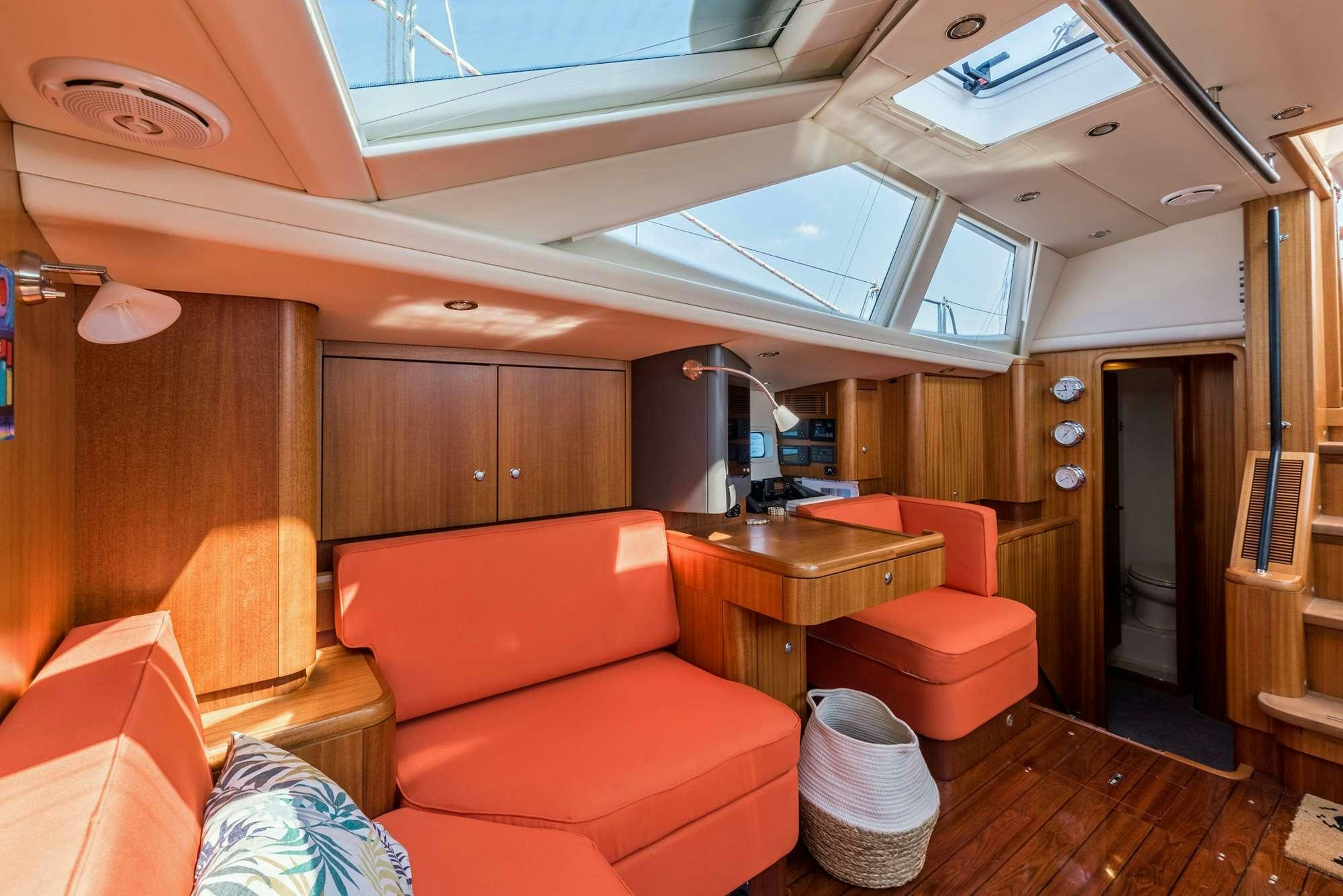 a living room with a couch and a table aboard LUNULATA  Yacht for Charter