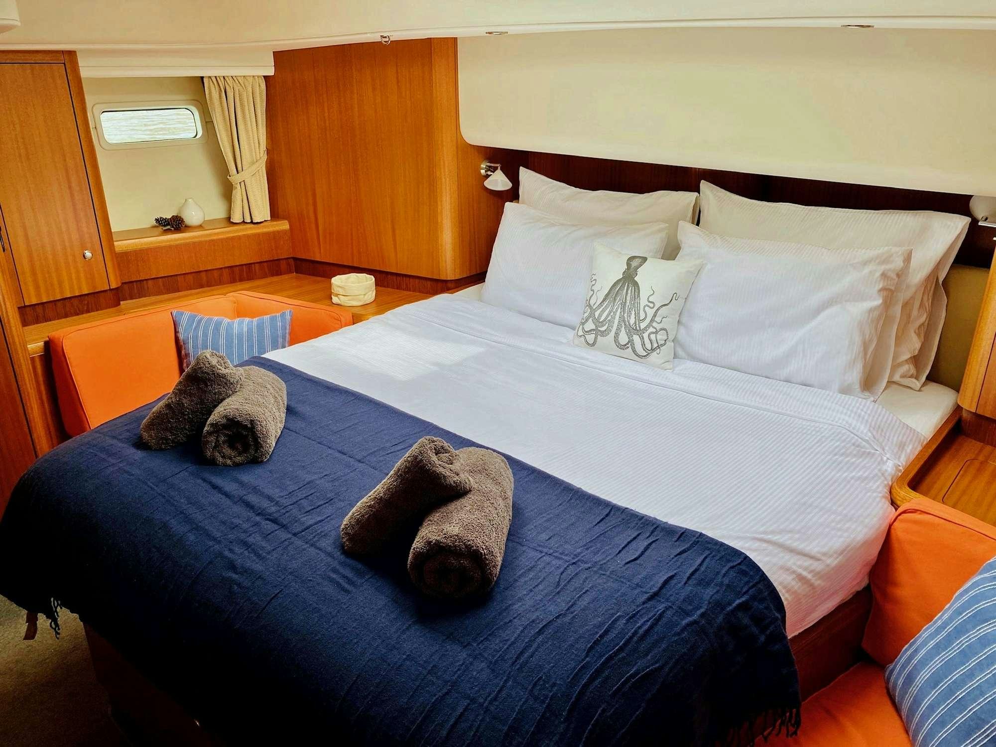 a group of cats lay on a bed aboard LUNULATA  Yacht for Charter
