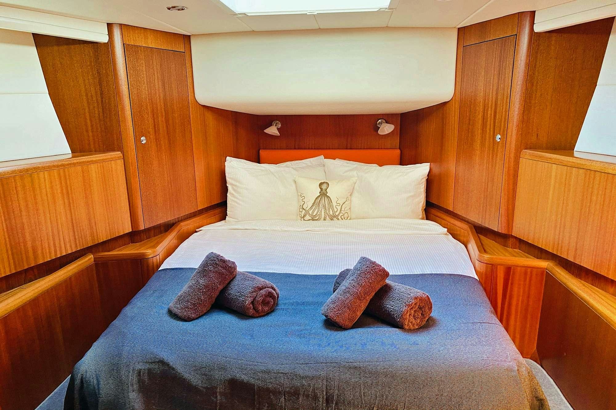 a bed with pillows aboard LUNULATA  Yacht for Charter