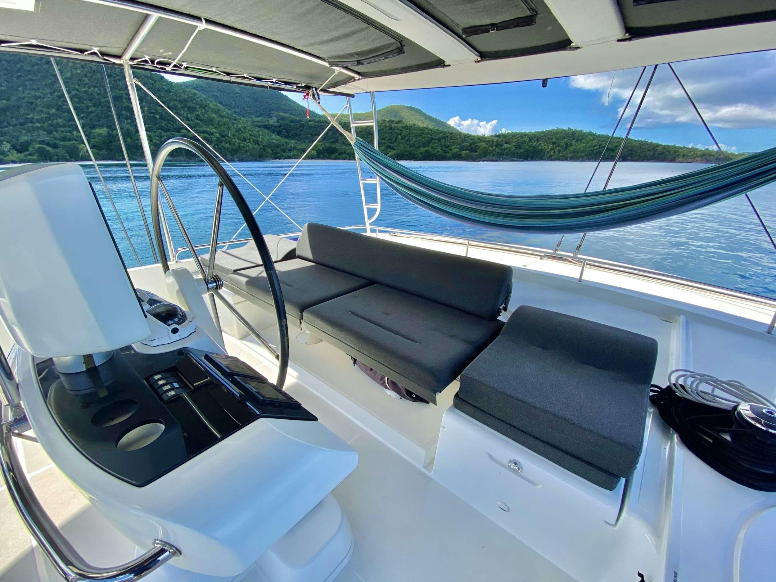 a boat with a seat aboard CHAMPAGNE L52 Yacht for Charter
