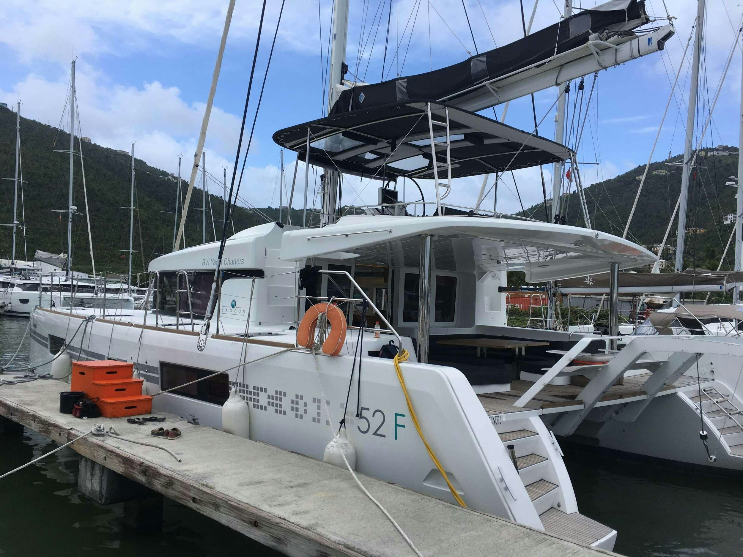 a boat docked at a pier aboard CHAMPAGNE L52 Yacht for Charter