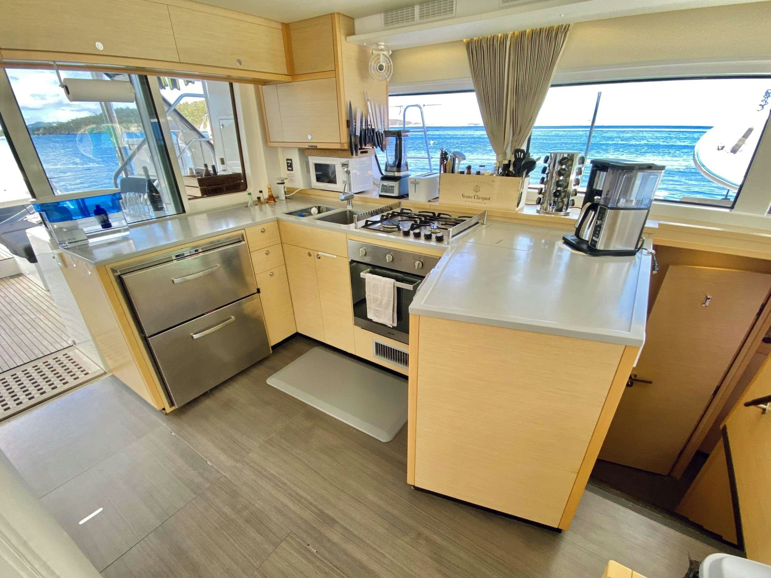 a kitchen with a stove and cabinets aboard CHAMPAGNE L52 Yacht for Charter