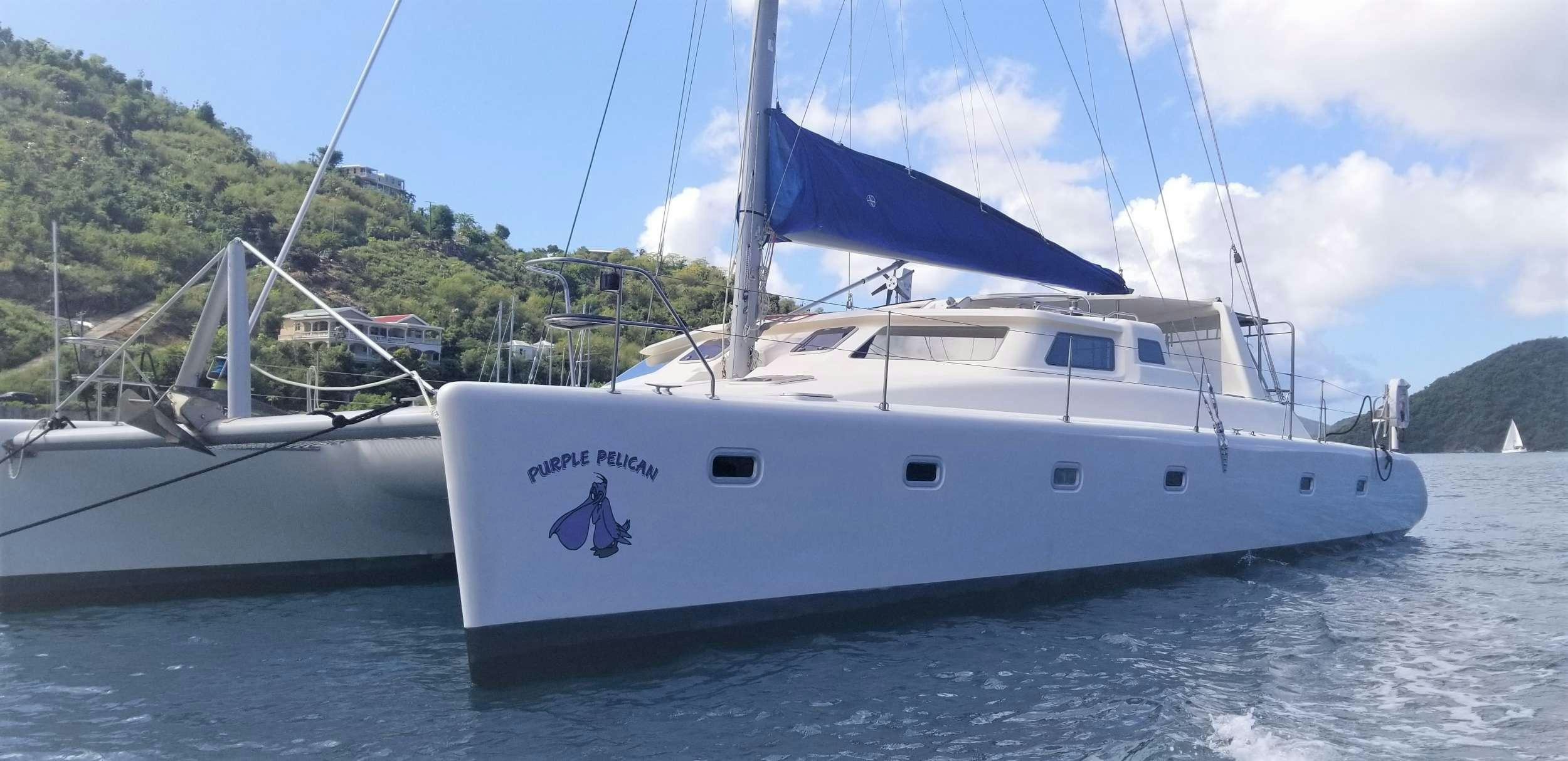 a couple of white boats on water aboard PURPLE PELICAN Yacht for Charter