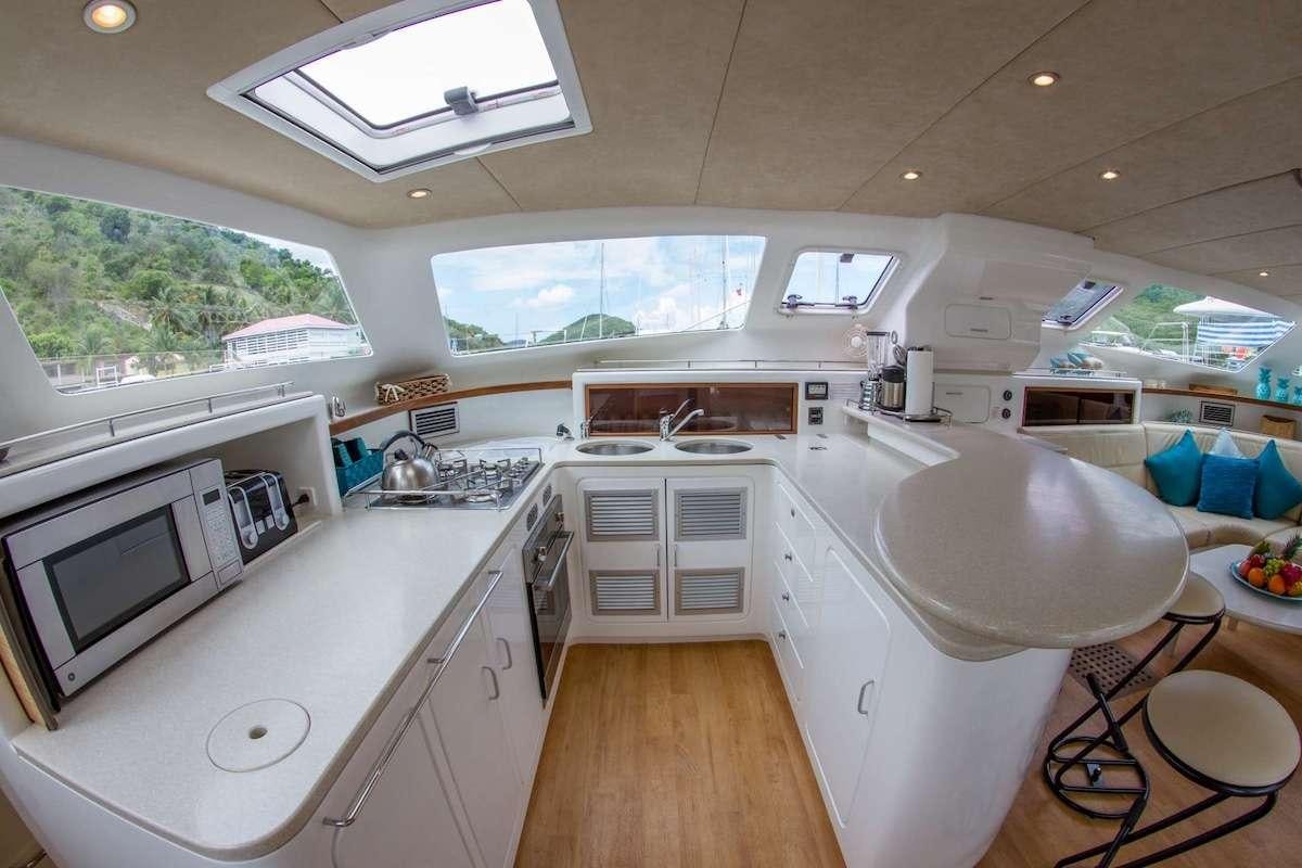 a kitchen with a large window aboard PURPLE PELICAN Yacht for Charter