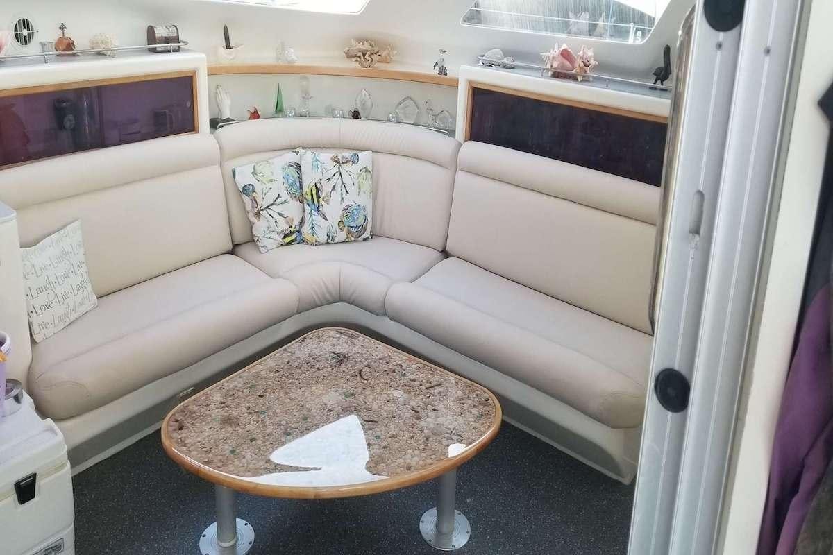 a couch with a coffee table aboard PURPLE PELICAN Yacht for Charter