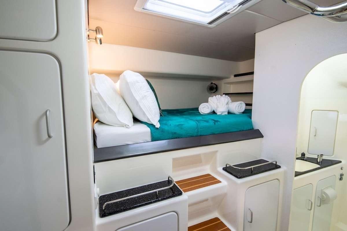 a hospital bed with a desk aboard PURPLE PELICAN Yacht for Charter