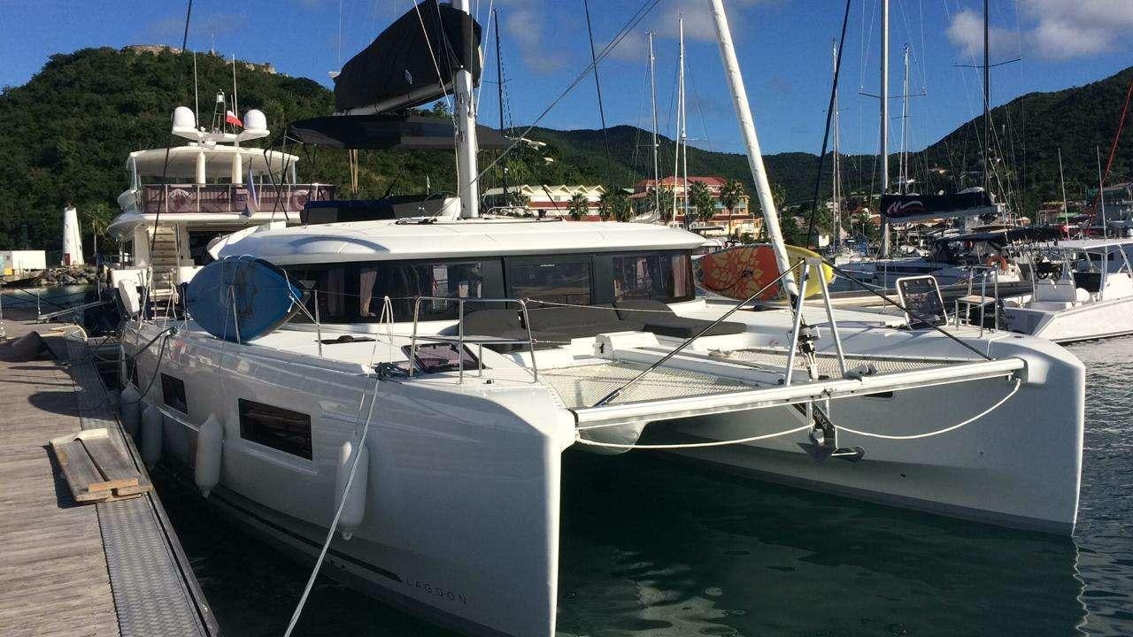a boat docked at a pier aboard CELAVIE Yacht for Charter