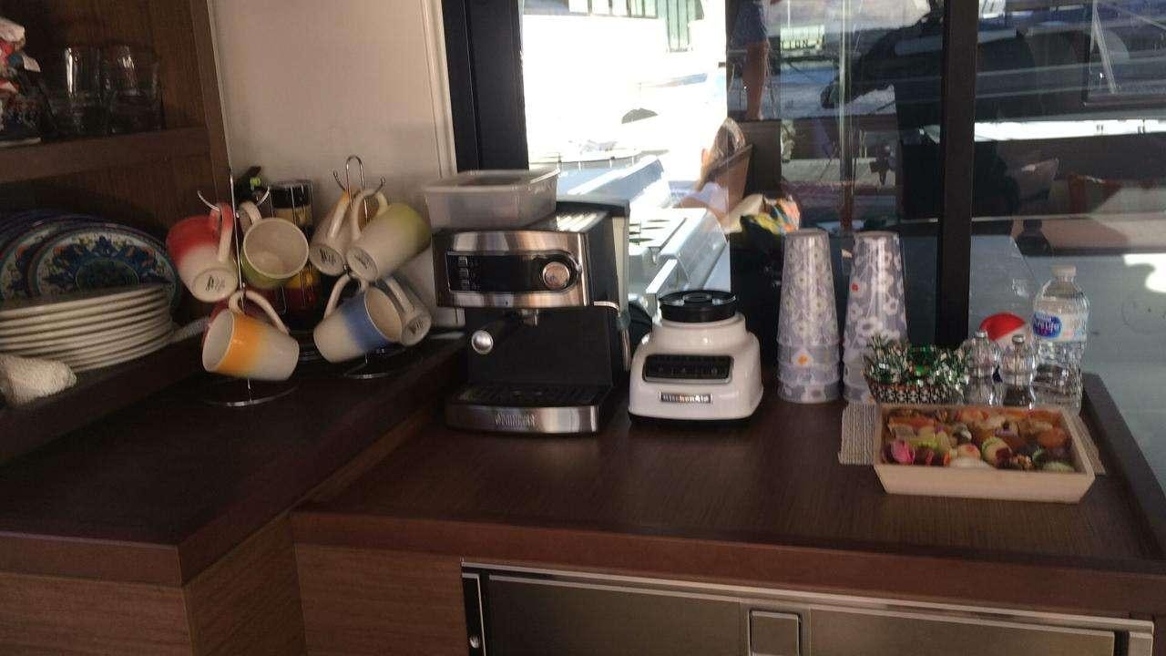 a kitchen counter with various items aboard CELAVIE Yacht for Charter