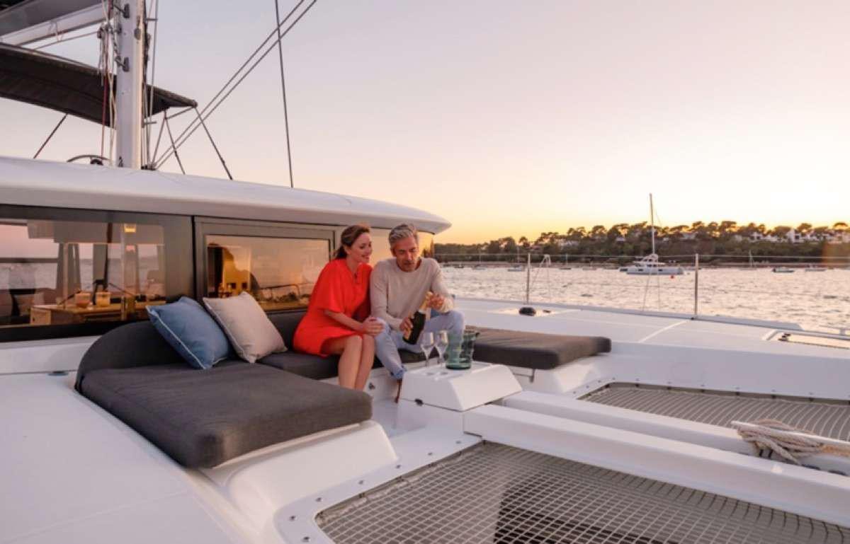 a couple sitting on a boat aboard CELAVIE Yacht for Charter