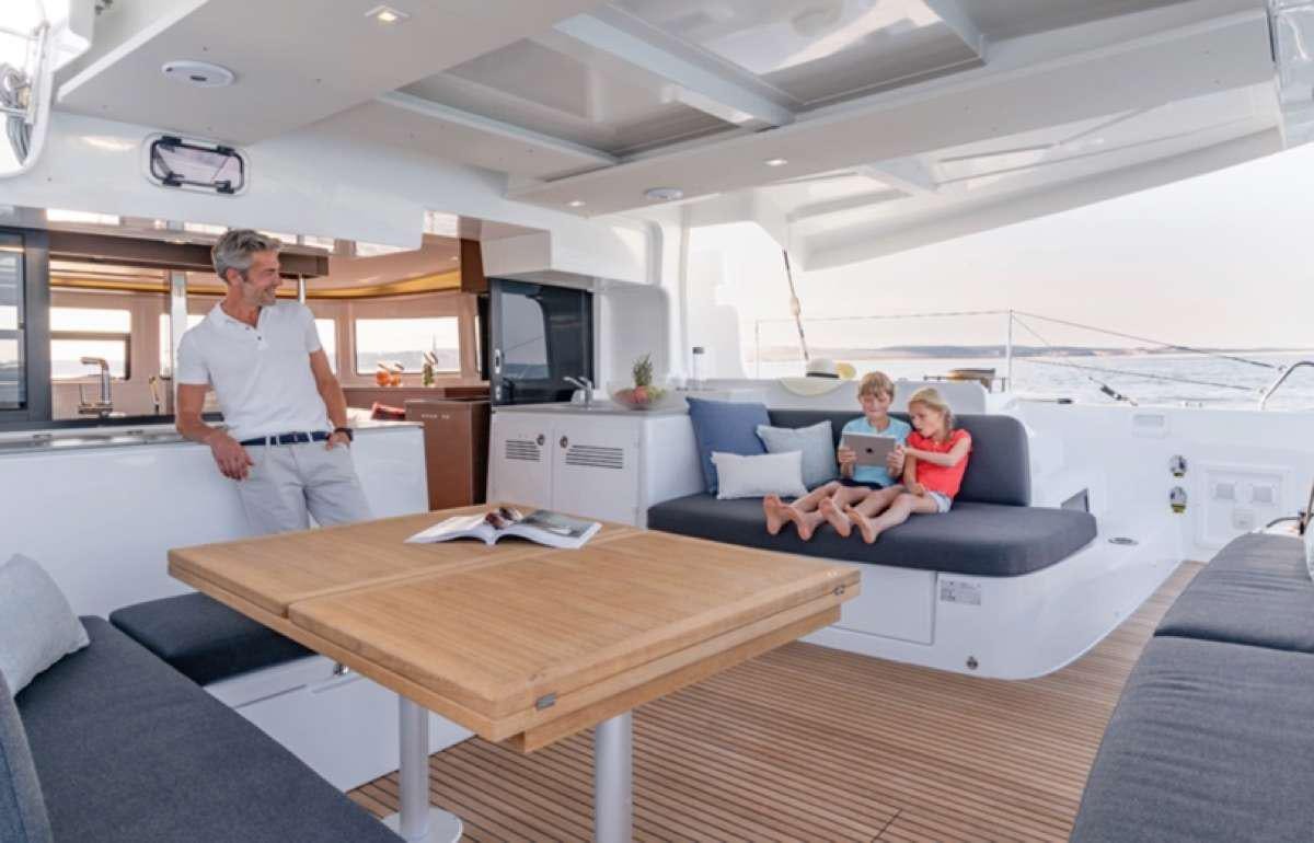 a person and a child in a tent aboard CELAVIE Yacht for Charter