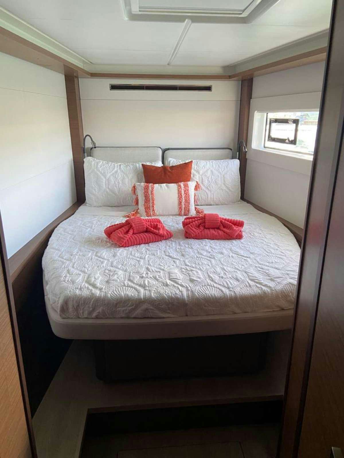 a bed with pillows on it aboard CELAVIE Yacht for Charter