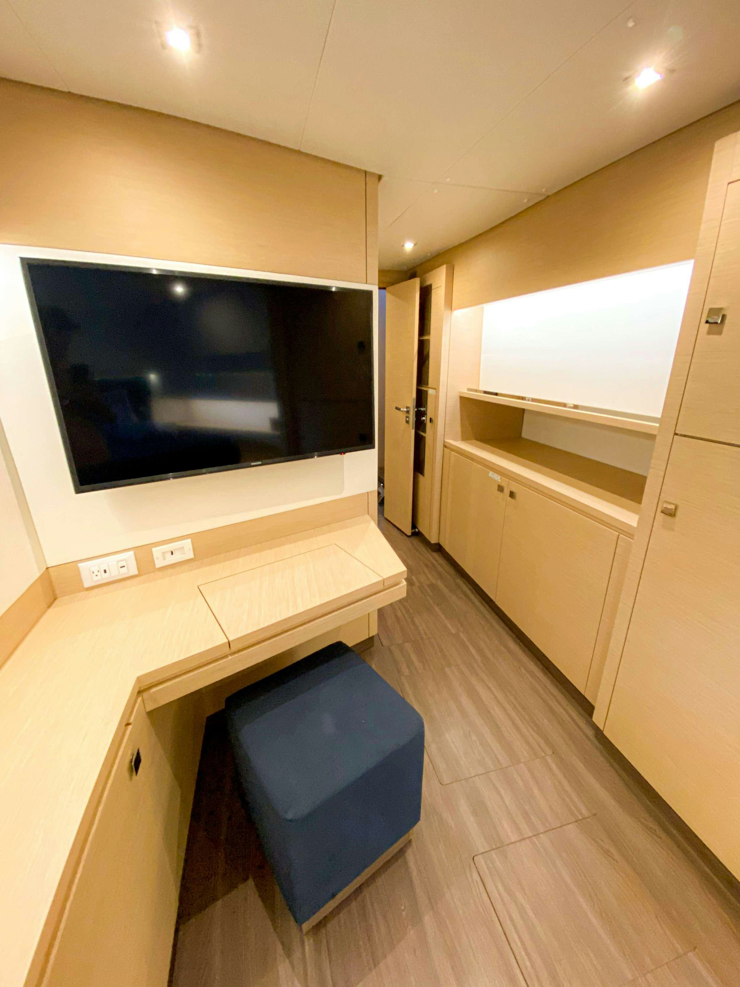 a room with a tv and a cabinet aboard Sol Mates Yacht for Charter