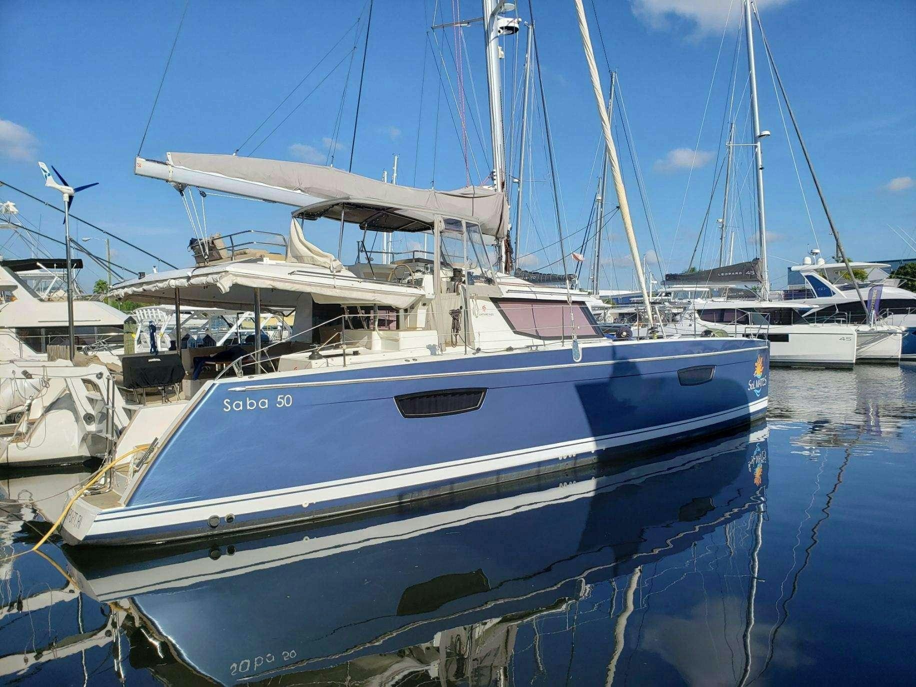 a group of boats are parked in a harbor aboard Sol Mates Yacht for Charter